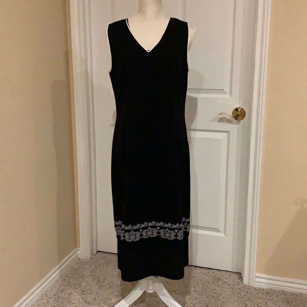 Sleek 100% poly, sleeveless black dress.  Calf length Sz 12